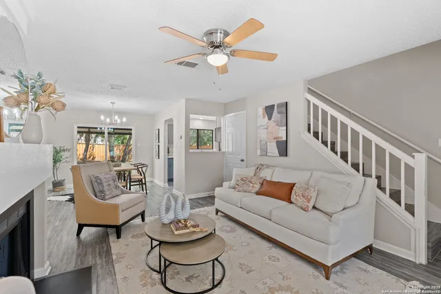 a living room with furniture and a chandelier