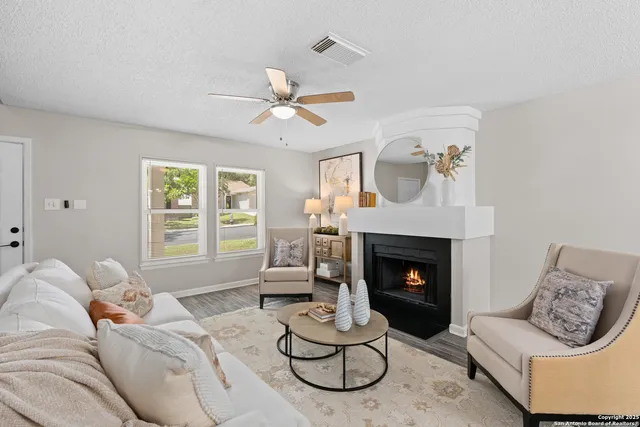 a living room with furniture chandelier and a fireplace