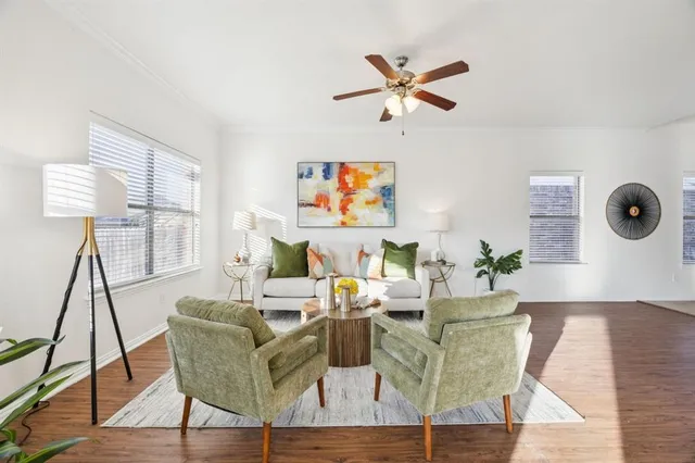 a living room with furniture and a wooden floor