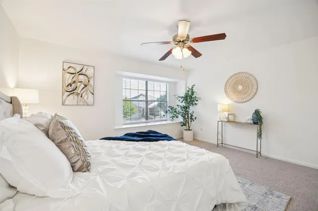 a view of an empty room with a ceiling fan