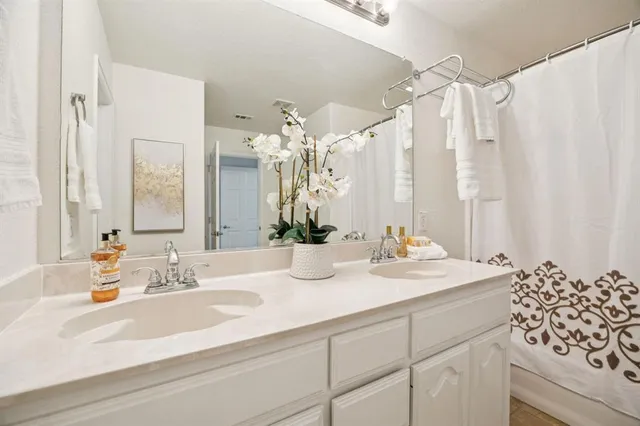 an empty room with a window and a ceiling fan