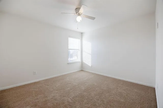 a view of a porch with a table and chairs