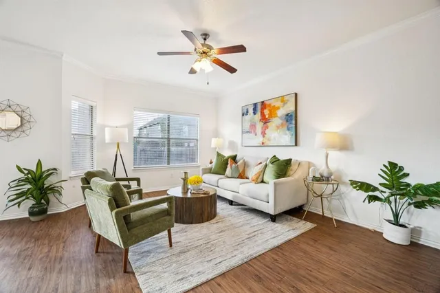 a living room with furniture and a potted plant