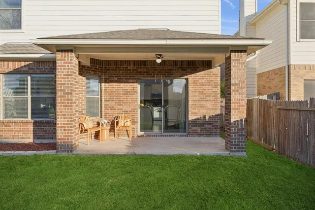 a view of a house with a yard and sitting area