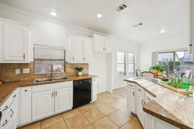 a kitchen with a sink stove and cabinets