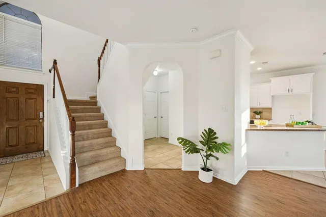 a bedroom with a large bed and a potted plant