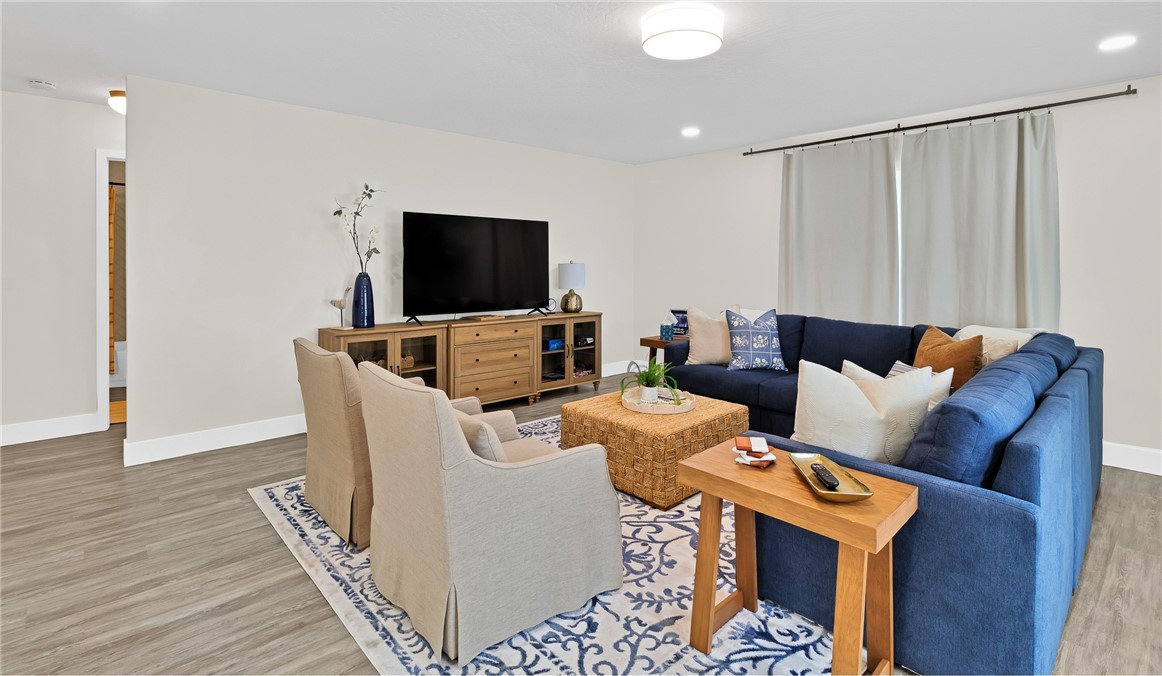7989 143rd Street Sebastian, FL 32958 - Photo 5 of 30 a living room with furniture and a flat screen tv