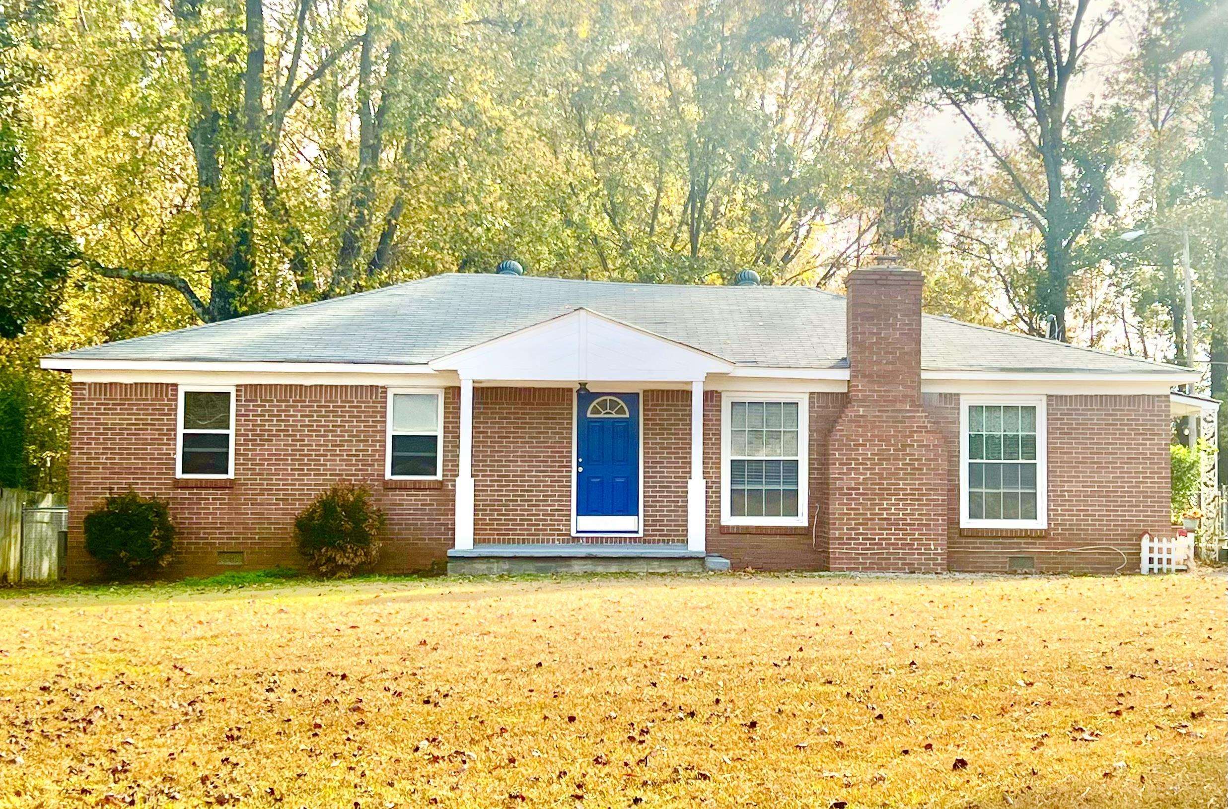 a view of a house with a yard and garage