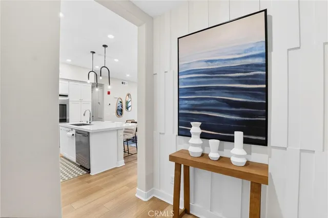 a kitchen with stainless steel appliances a stove a sink a kitchen island with a dining table and chairs