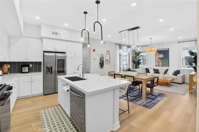 a kitchen with center island table and chairs