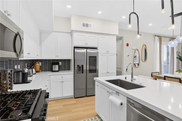 a kitchen with a sink a stove and cabinets