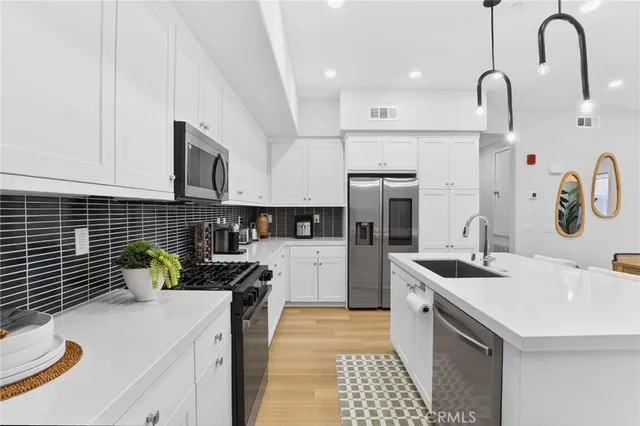 a kitchen with a table chairs microwave and cabinets