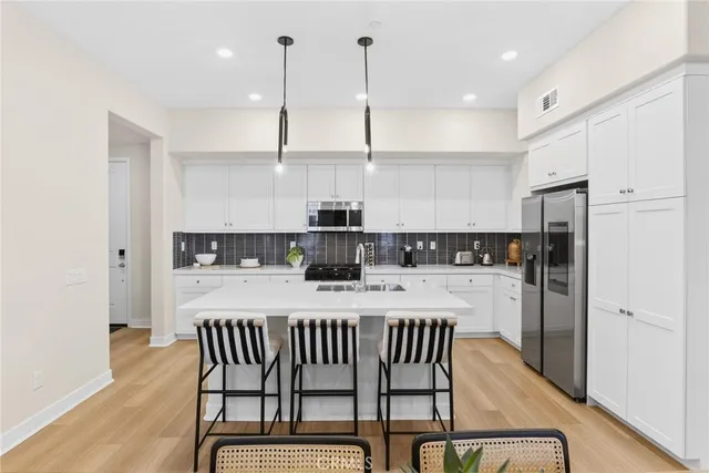 a kitchen with a white cabinets and appliances