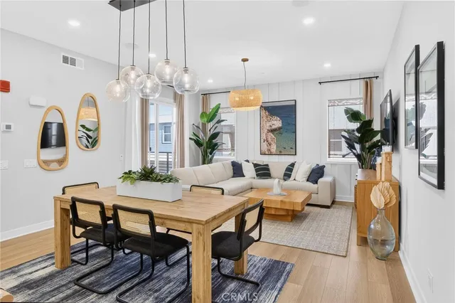 a view of a dining room with furniture and chandelier