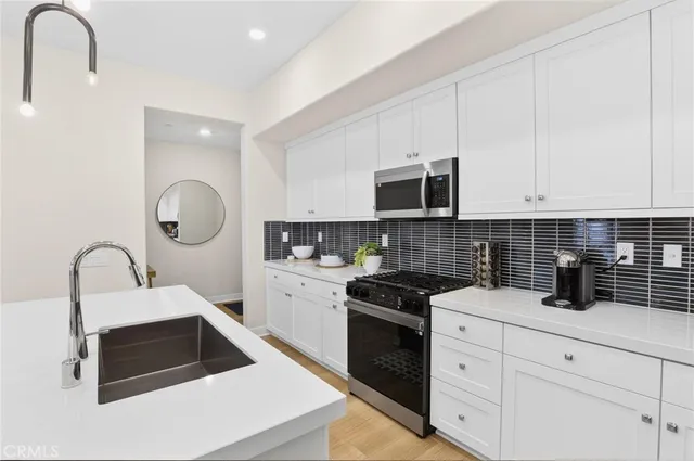 a kitchen that has a sink and a stove