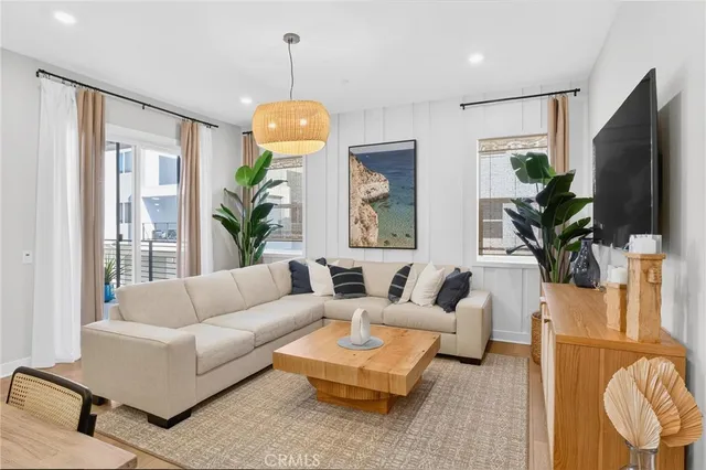 a living room with furniture a large window and a flat screen tv