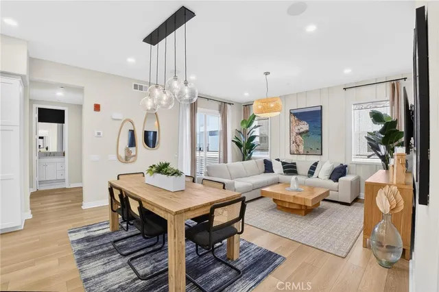 a living room with furniture a table and a chandelier