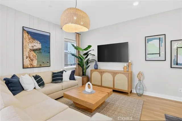 a living room with furniture a chandelier a large window and a chandelier