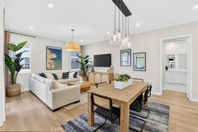 a living room with stainless steel appliances kitchen island granite countertop furniture and a dining table