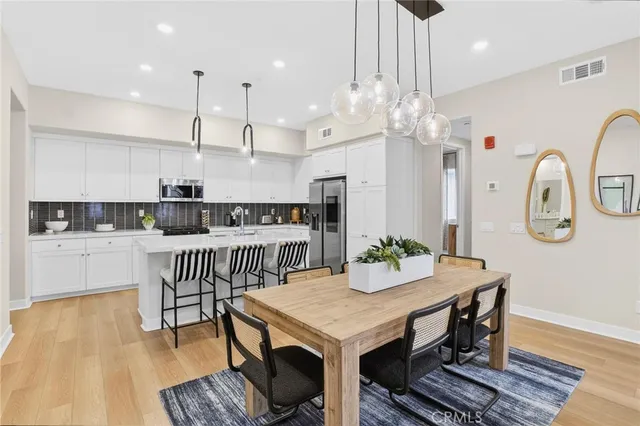 a large kitchen with a table and chairs