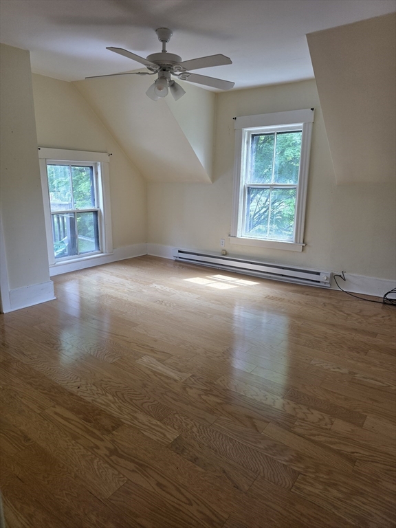 48 Maple Street, Unit 2 Holden, MA 01520 - Photo 7 of 11 an empty room with wooden floor chandelier fan and windows