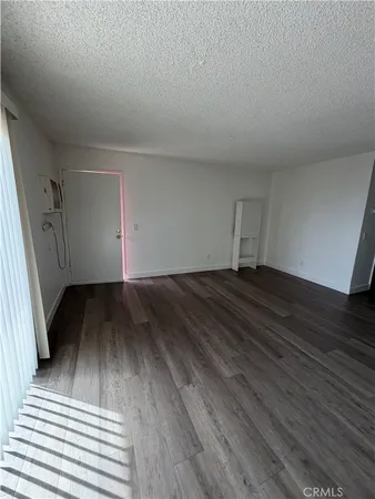 a view of a room with wooden floor and staircase