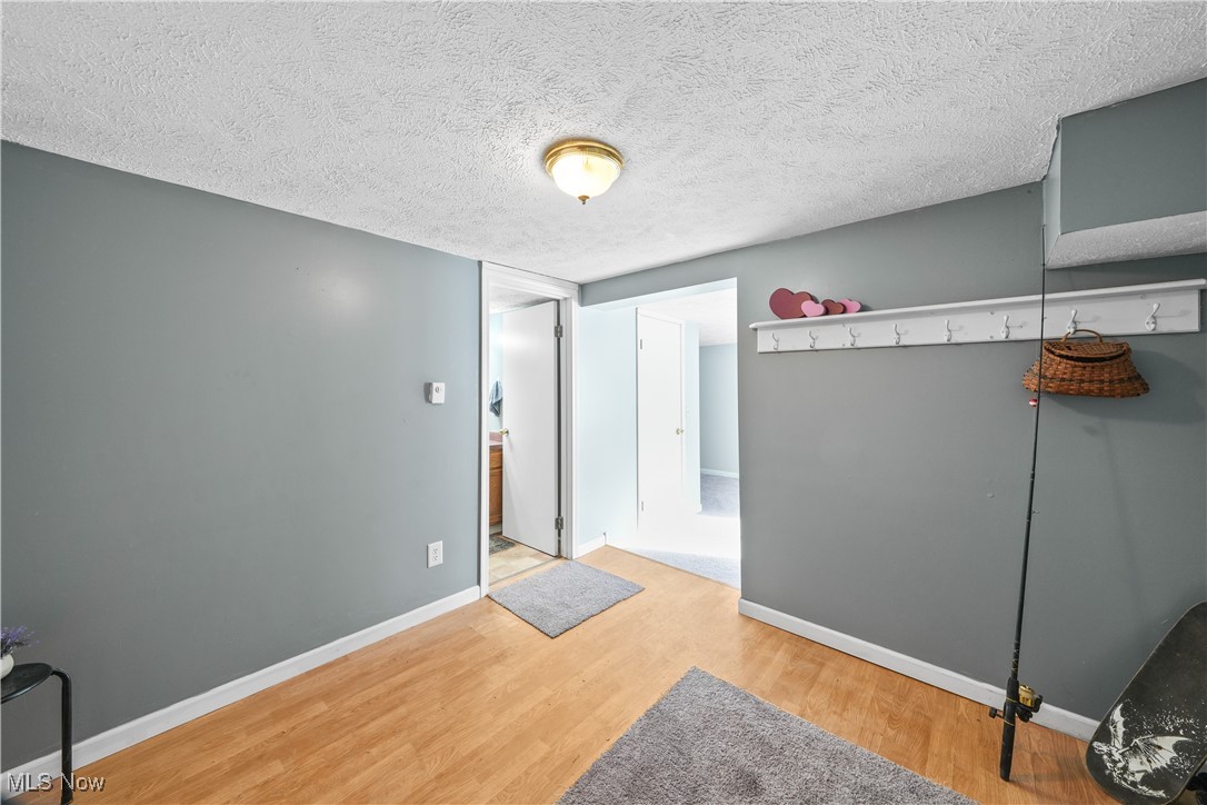 4947 Wayland Road Diamond, OH 44412 - Photo 24 of 43 Room featuring hardwood / wood-style flooring and a textured ceiling