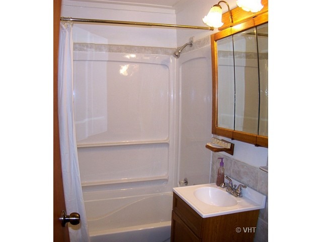 2547 Caton Farm Road Joliet, IL 60435 - Photo 14 of 17 a bathroom with a sink and a mirror