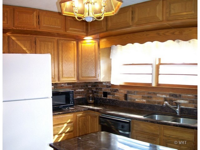 2547 Caton Farm Road Joliet, IL 60435 - Photo 3 of 17 a kitchen with stainless steel appliances kitchen island granite countertop a sink window and cabinets