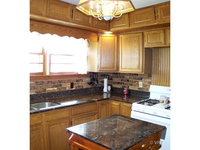 2547 Caton Farm Road Joliet, IL 60435 - Photo 4 of 17 a kitchen with stainless steel appliances granite countertop a sink stove and cabinets