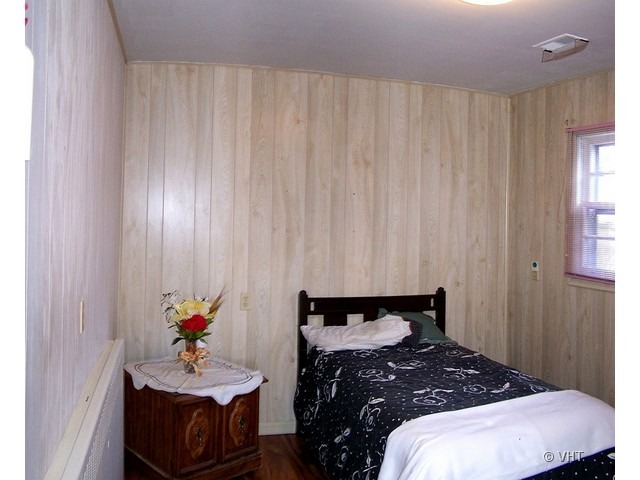 2547 Caton Farm Road Joliet, IL 60435 - Photo 9 of 17 a bedroom with a bed and a dresser