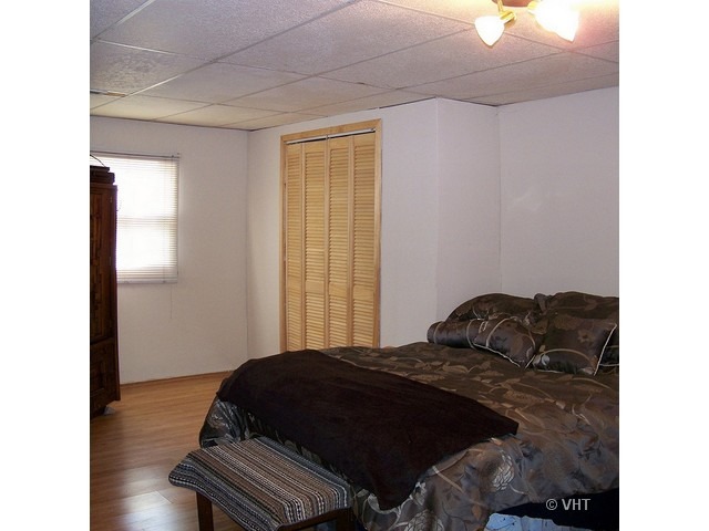 2547 Caton Farm Road Joliet, IL 60435 - Photo 10 of 17 a bedroom with a bed window and a mirror