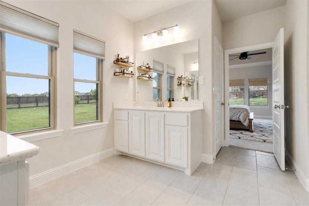 1205 Redbud Street Howe, TX 75459 - Photo 15 of 40 a en suite bathroom with a sink mirror and a bath tub