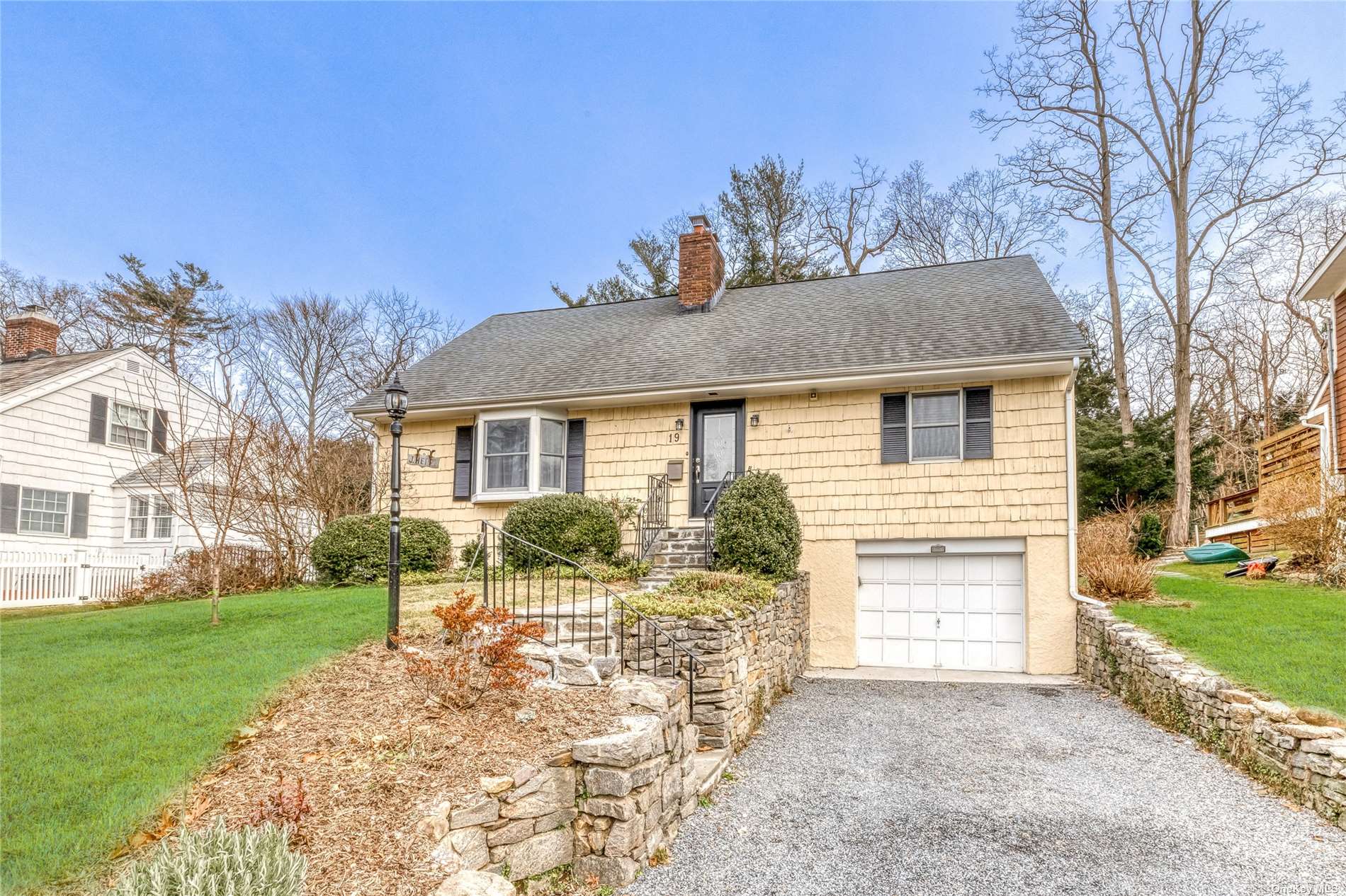 19 Beverly Road Port Washington, NY 11050 - Photo 1 of 1 a front view of a house with a yard and garage