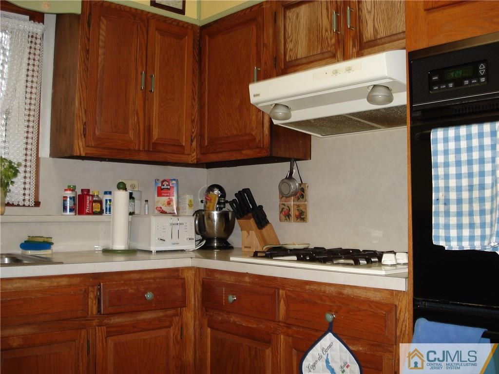 10 Morningside Road Colonia, NJ 07067 - Photo 17 of 18 a kitchen with stainless steel appliances granite countertop a refrigerator and a stove top oven