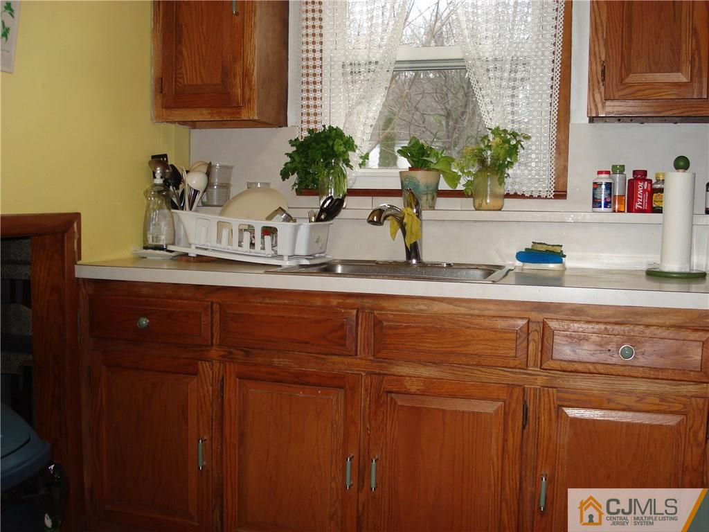 10 Morningside Road Colonia, NJ 07067 - Photo 18 of 18 a kitchen with stainless steel appliances granite countertop a sink and cabinets