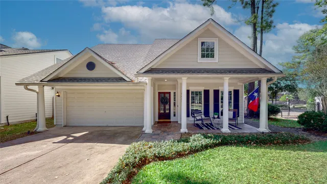 a front view of a house with a porch and seating space