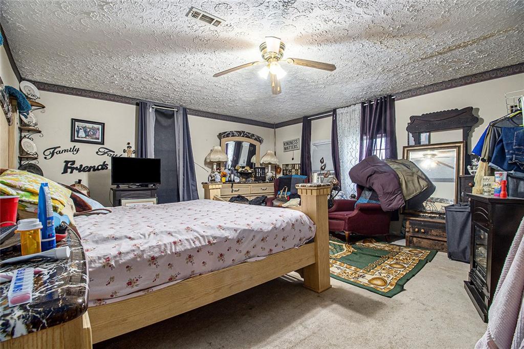 399 Rudy York Road Northwest Cartersville, GA 30121 - Photo 11 of 25 a bedroom with a bed a flat screen tv and dresser