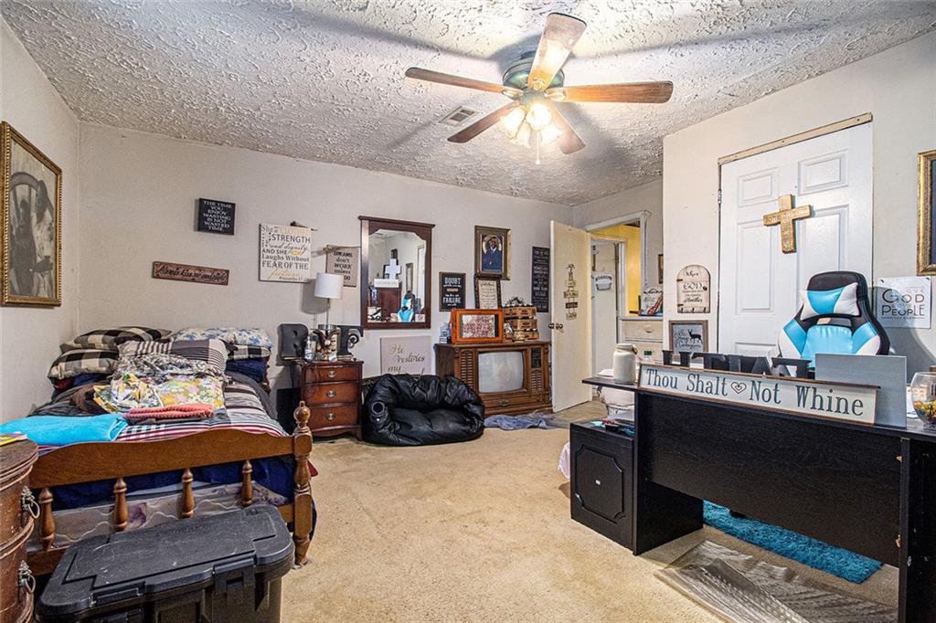 399 Rudy York Road Northwest Cartersville, GA 30121 - Photo 12 of 25 a living room with furniture a chandelier and a flat screen tv