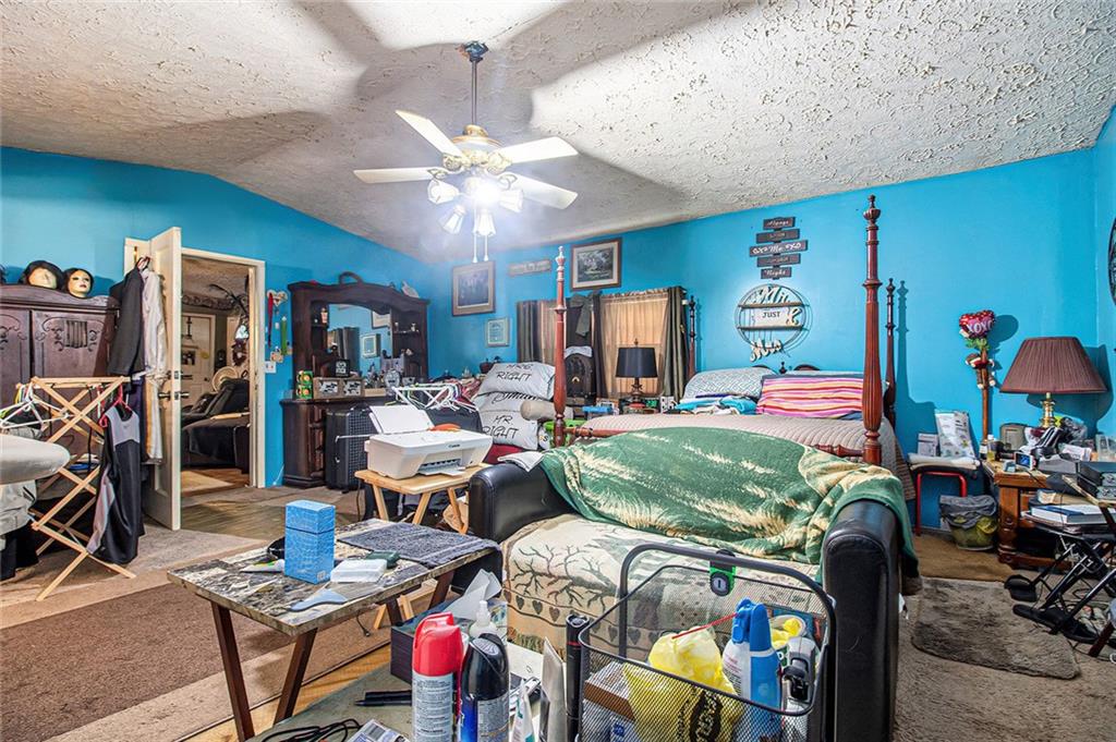 399 Rudy York Road Northwest Cartersville, GA 30121 - Photo 15 of 25 a bed room with furniture and a chandelier