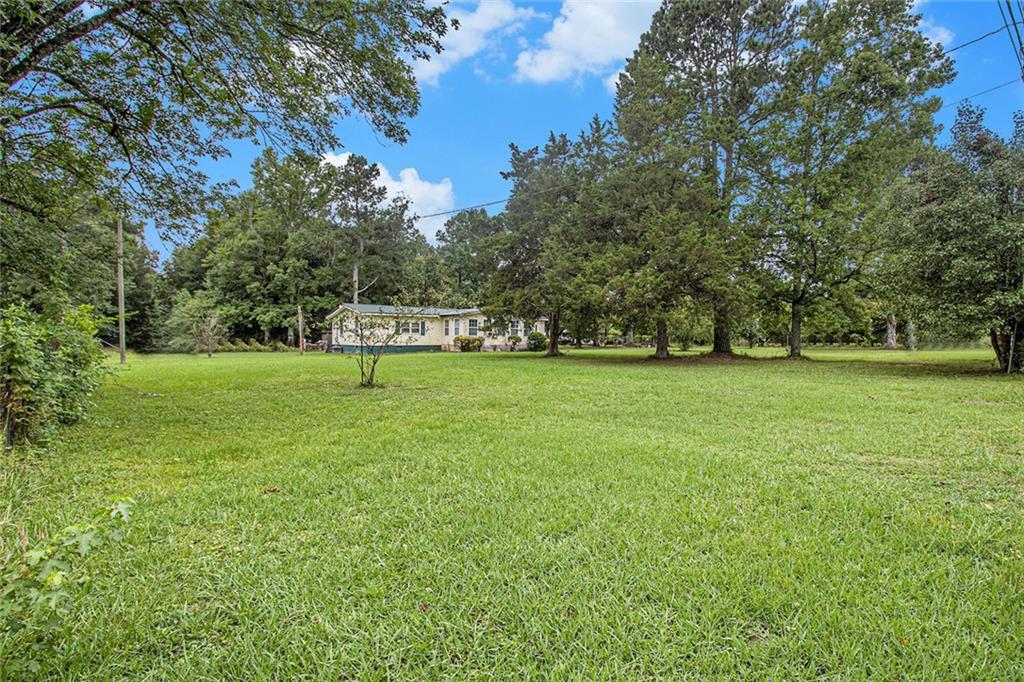 399 Rudy York Road Northwest Cartersville, GA 30121 - Photo 24 of 25 a view of a green field with trees in the background