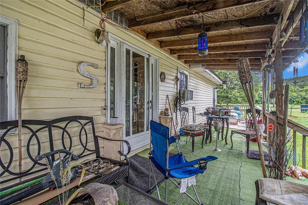 399 Rudy York Road Northwest Cartersville, GA 30121 - Photo 3 of 25 a view of a chairs and table in patio with a barbeque