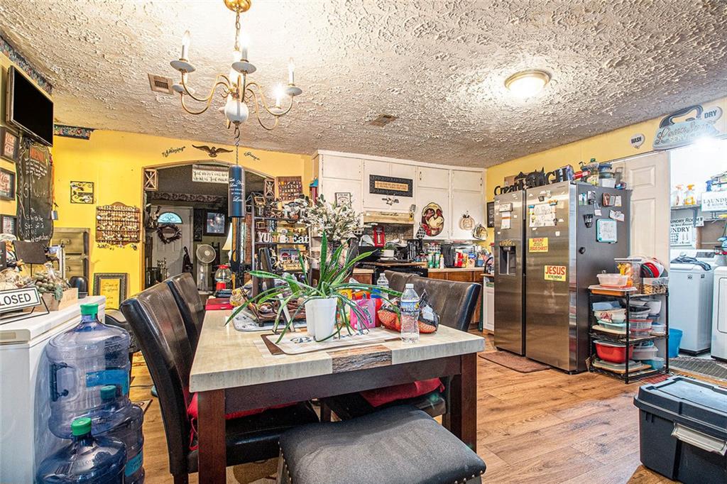399 Rudy York Road Northwest Cartersville, GA 30121 - Photo 9 of 25 a view of a dining room with furniture a chandelier and wooden floor