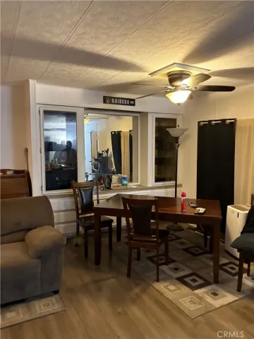 a living room with furniture a flat screen tv and kitchen view