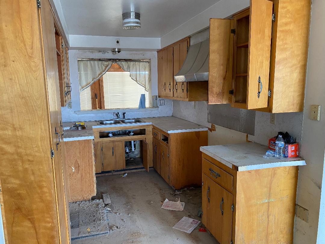 63325 Mesa Verde Joshua Tree, CA 92252 - Photo 35 of 39 a kitchen with a sink stove and cabinets