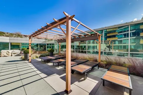a view of a swimming pool with outdoor seating