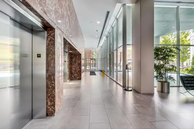 a hallway with wooden floor table and chairs