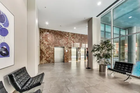 a lobby with furniture and potted plants