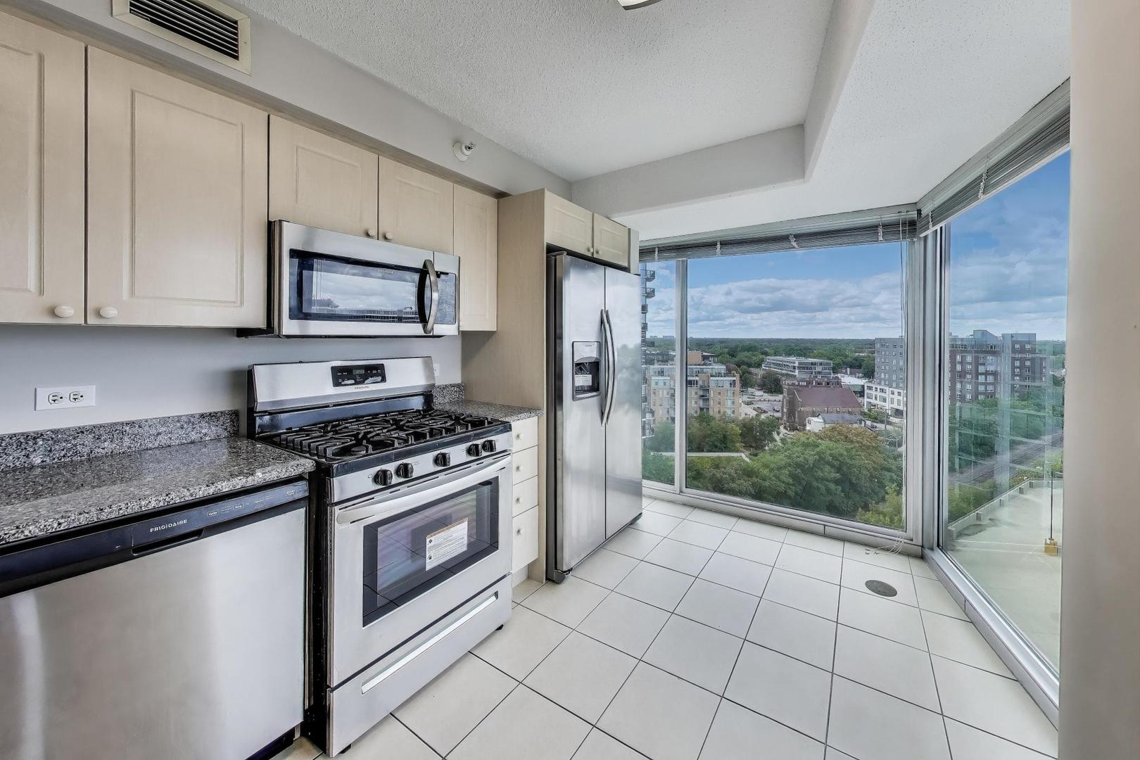 1720 Maple Avenue, Unit 1360 Evanston, IL 60201 - Photo 10 of 37 a kitchen with stainless steel appliances a stove a sink and a microwave