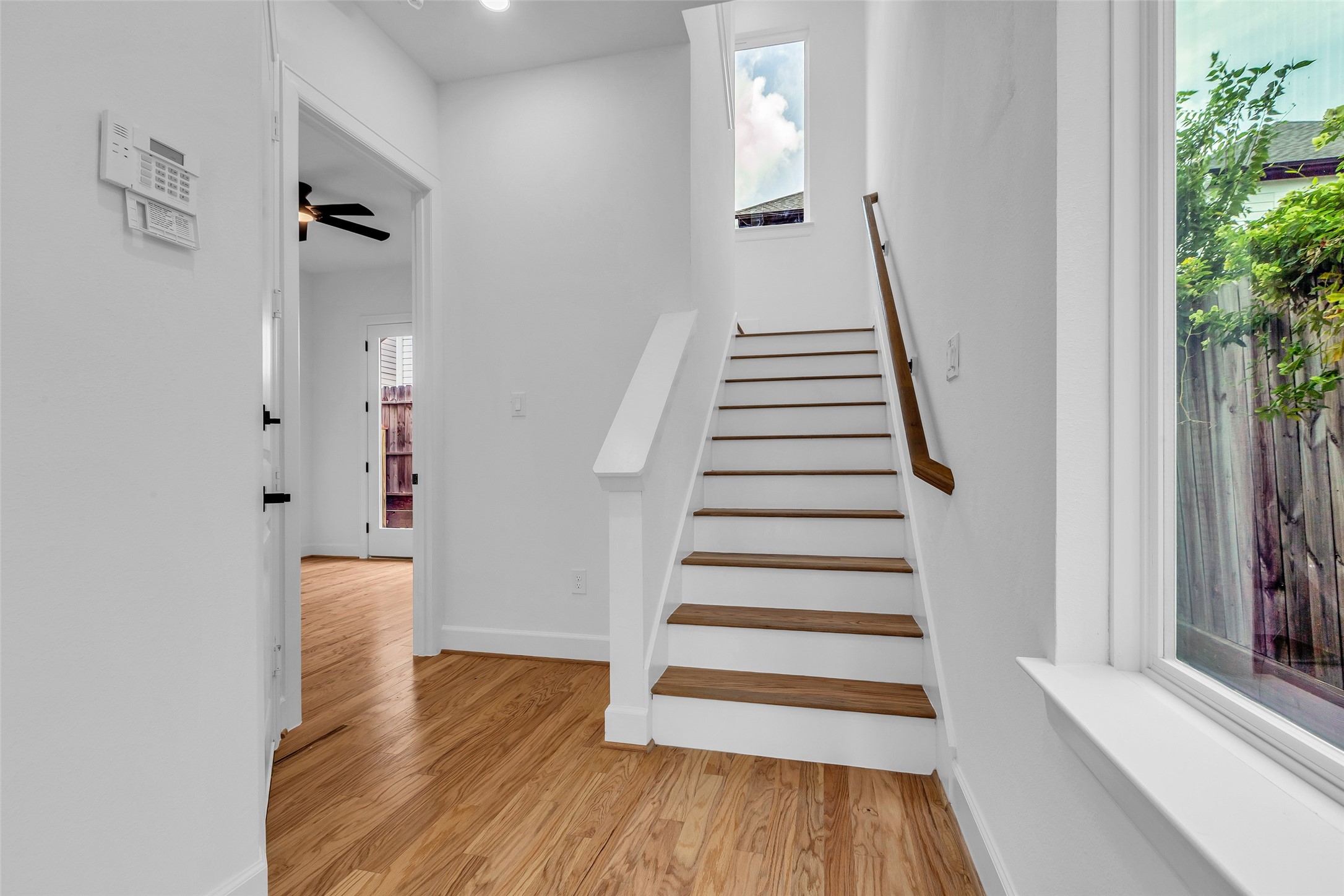 9426 Campbell Road, Unit A Houston, TX 77080 - Photo 2 of 26 a view of a hallway with wooden floor and staircase